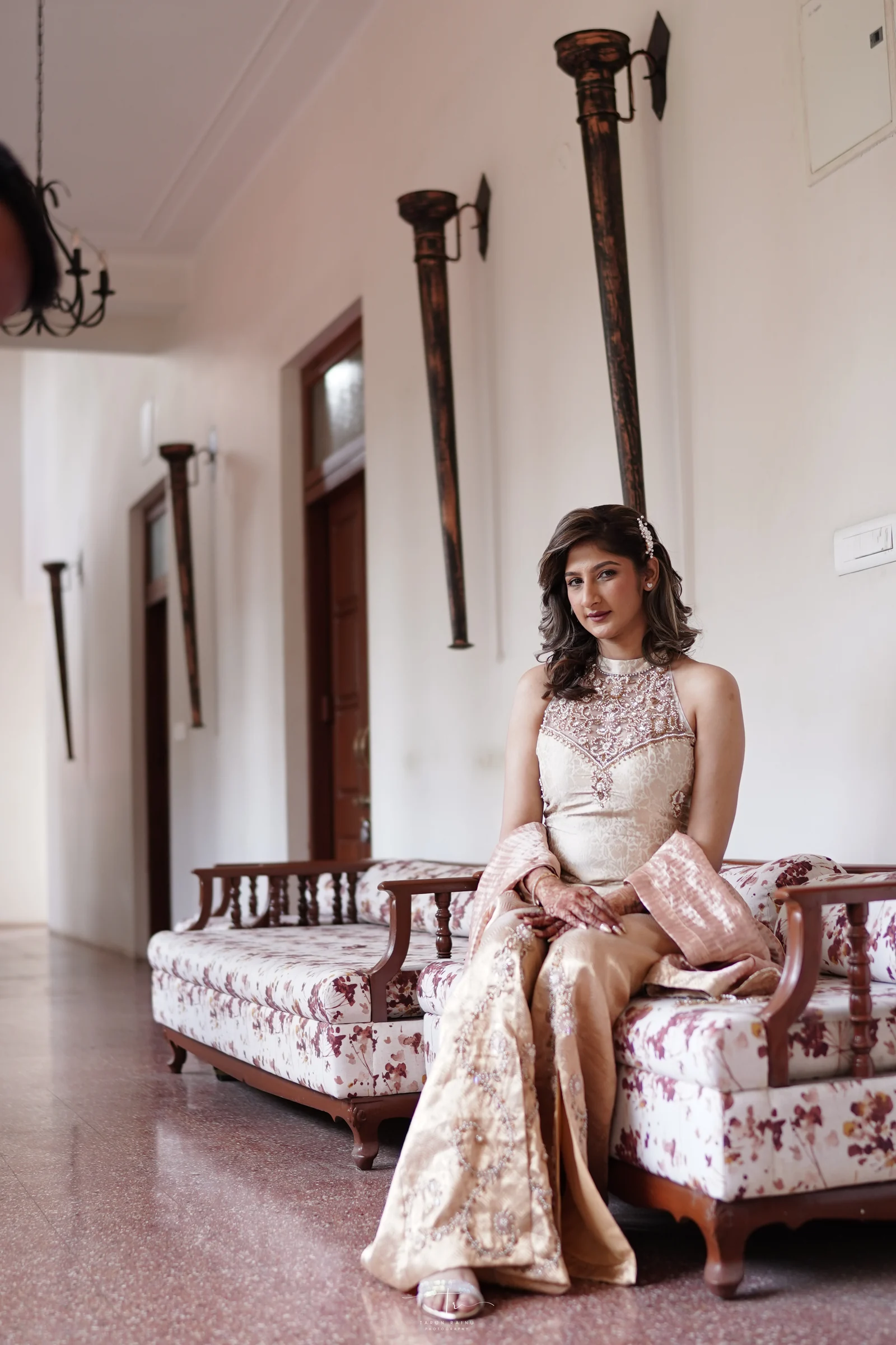 Bride seated in an ivory couture look inside the atelier