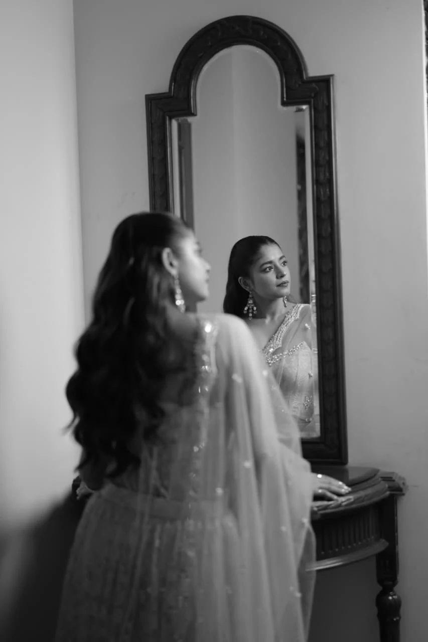 Black and white bridal mirror portrait with veil