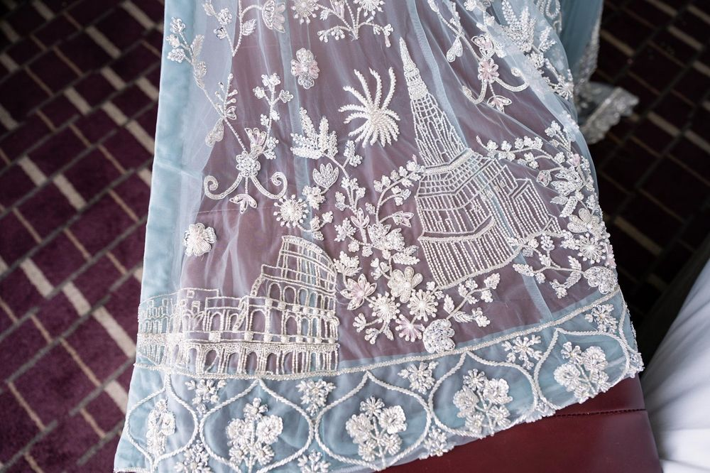 Hand-beaded architectural and floral motifs worked into powder-blue bridal tulle