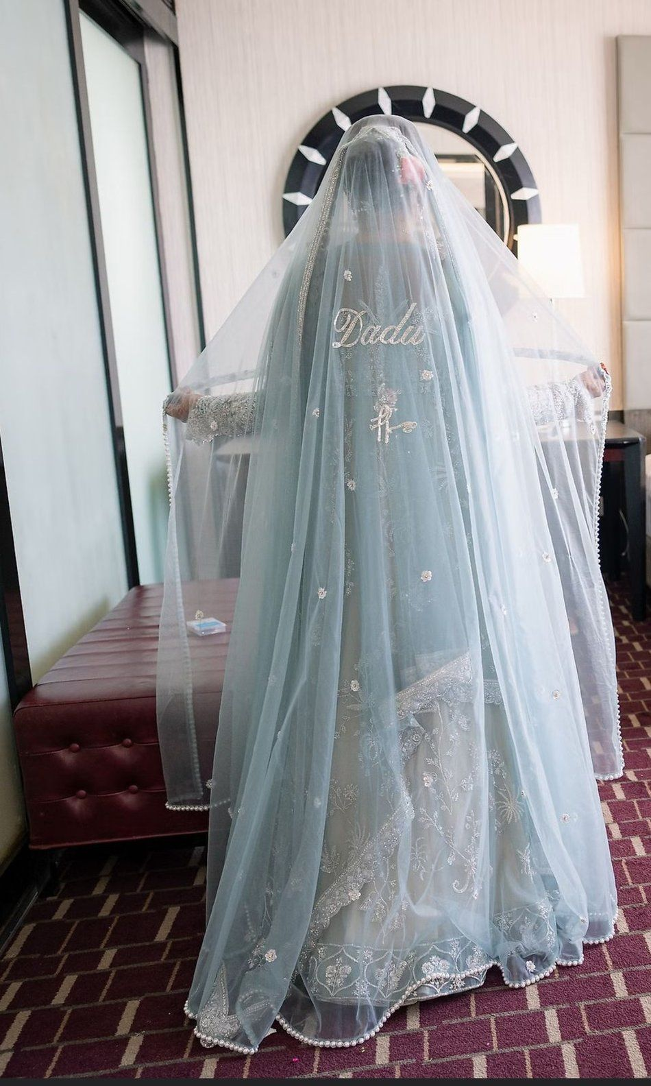 Full-length bridal veil embroidered with a grandparent's name, seen from behind
