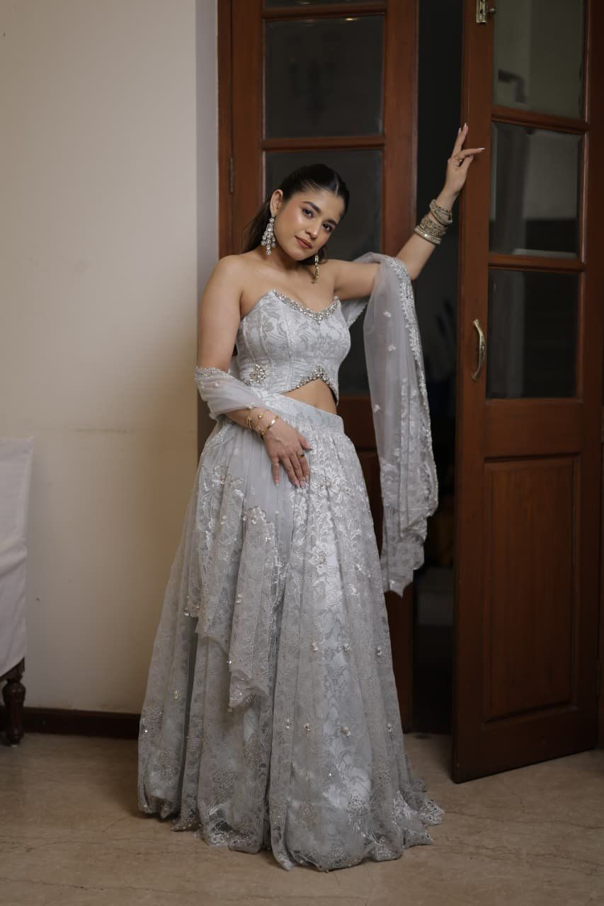 Bride in a bespoke silver-grey lehenga with lace and sequin handwork by Gulnaz Amin Atelier in Pune