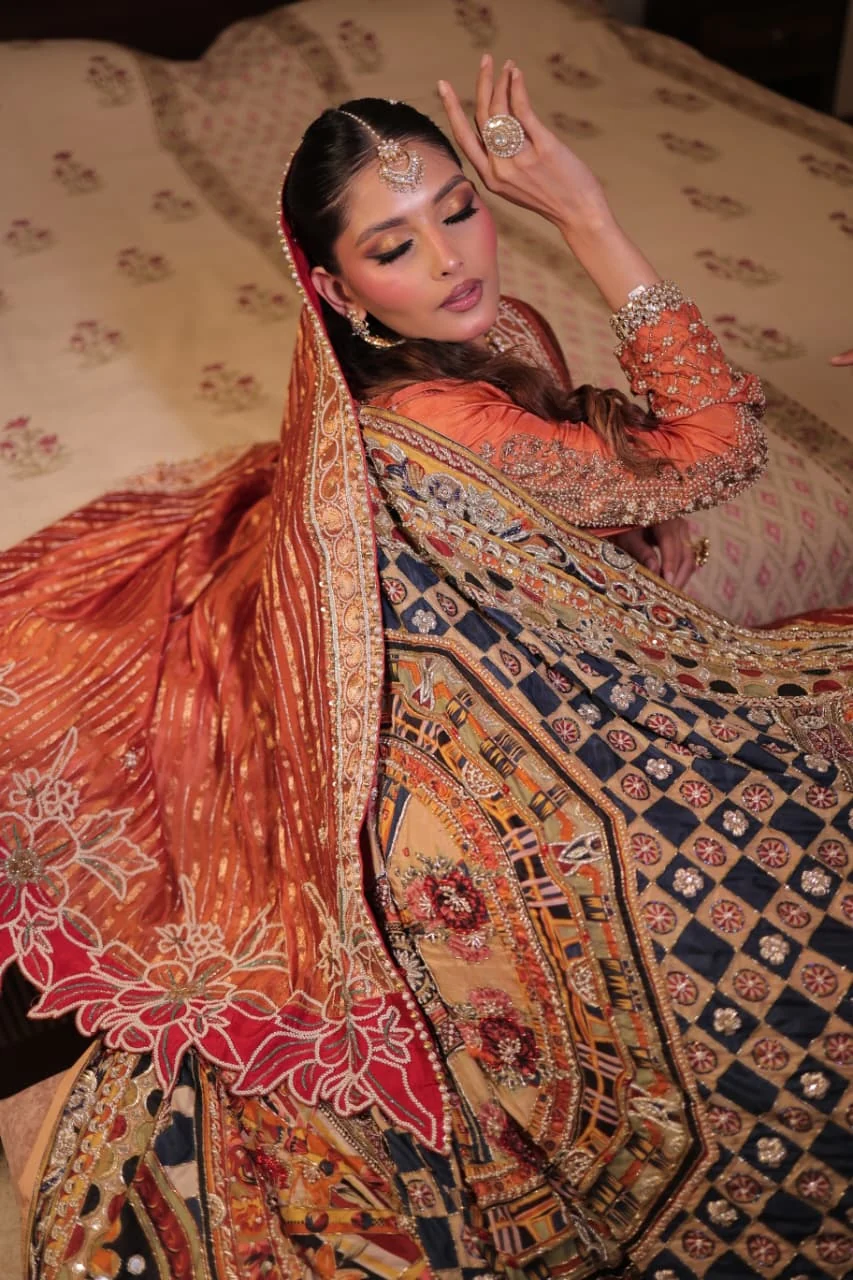 Editorial bridal portrait with richly embroidered red and gold drape