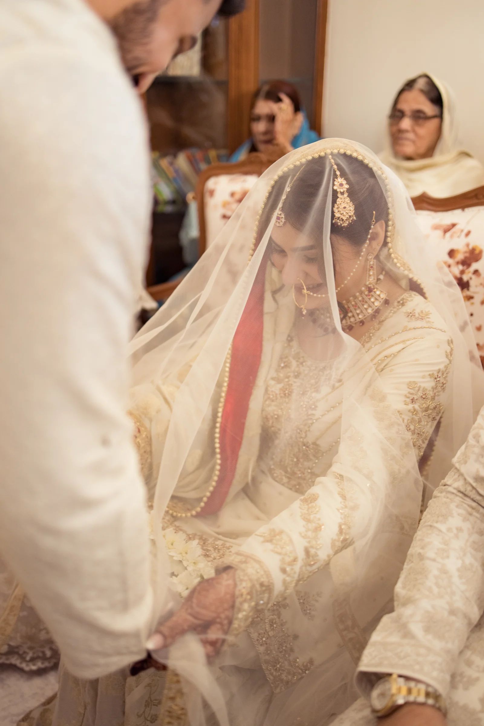 Veiled bride during a family wedding ceremony moment