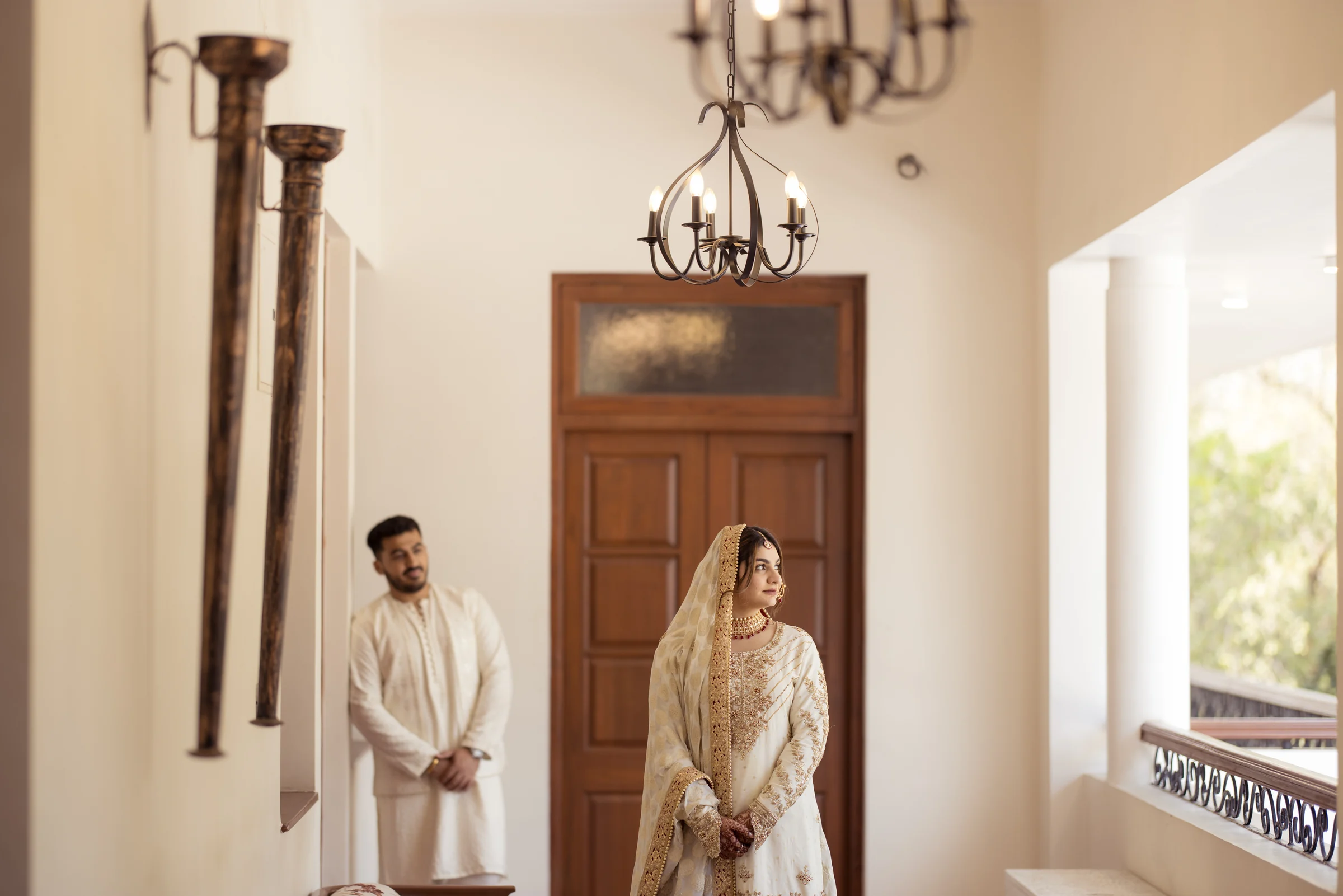 Bride and groom portrait in coordinated ivory wedding couture