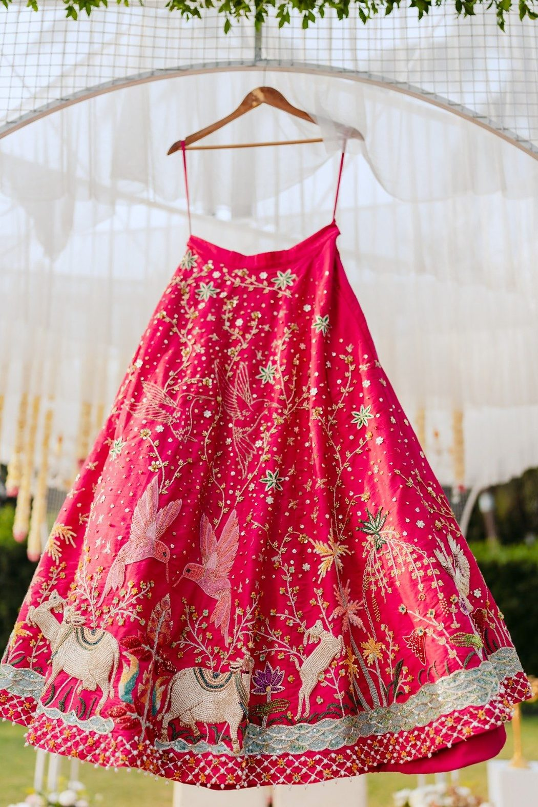 Hand-embroidered pink bridal lehenga skirt with beaded camels, hummingbirds, palms and lotus motifs